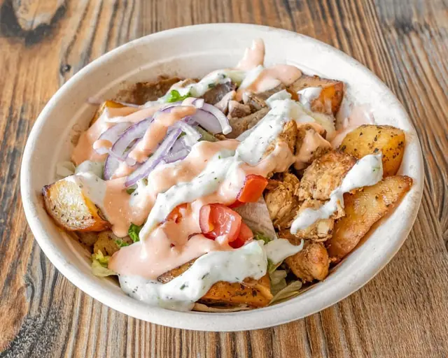 Chicken bowl on a lemon potato base topped with tzatziki and pita sauce