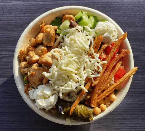 Loaded bowl with chicken souvlaki, mozzarella, chickpeas, feta, cucumber and grilled veggies
