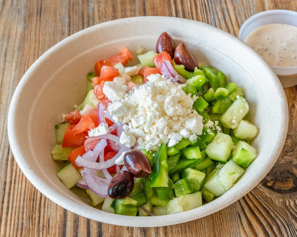 Village Salad with tomato, cucumber, green pepper, red onion, crumbled feta and kalamata olives